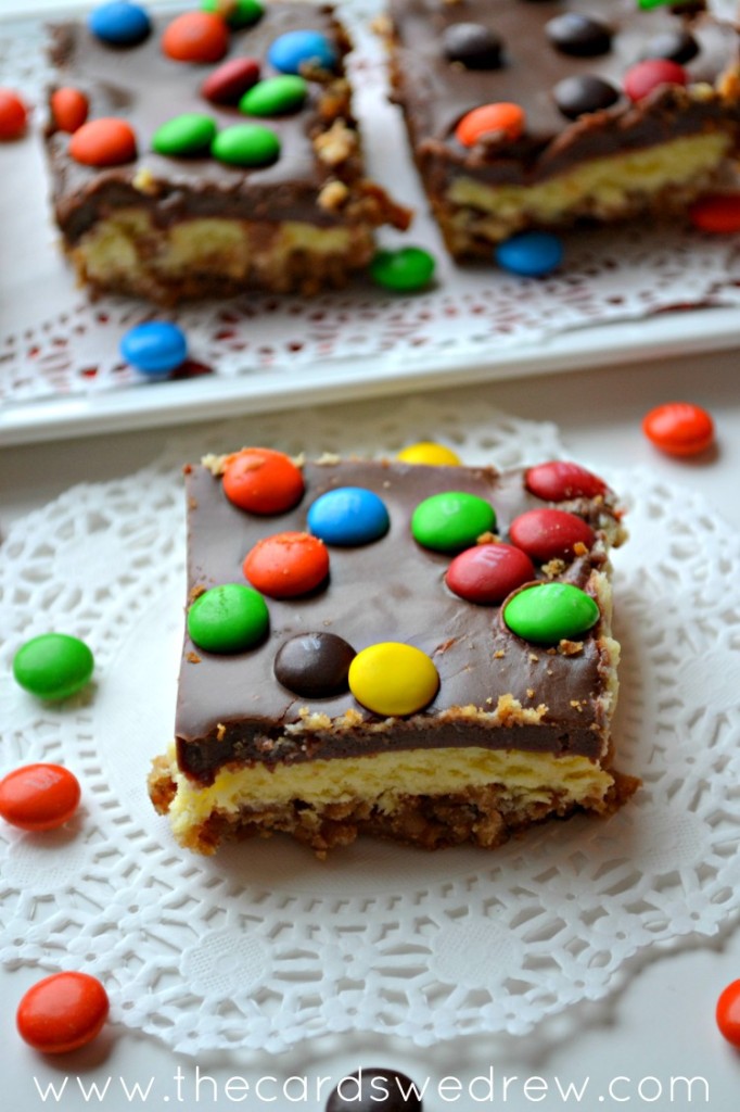 M&M Cheesecake Bar with Pretzel Crust and Chocolate Icing from The Cards We Drew