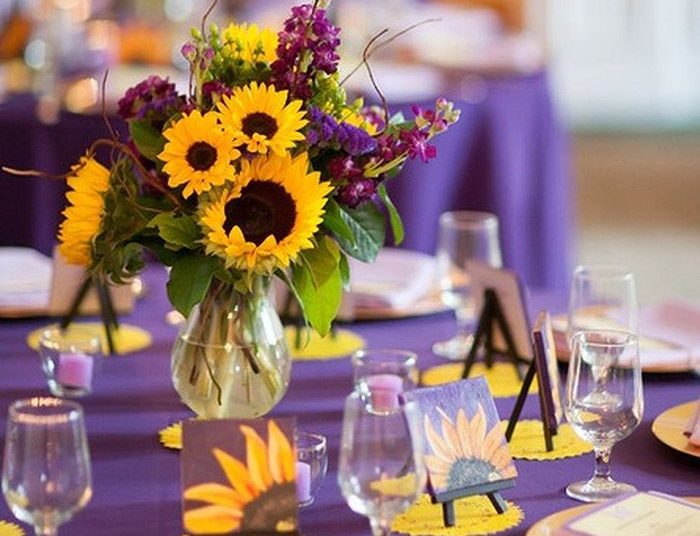 Reception table setting - Yellow tablecloth with black napkins and white  ribbons tied to black chairs, yellow